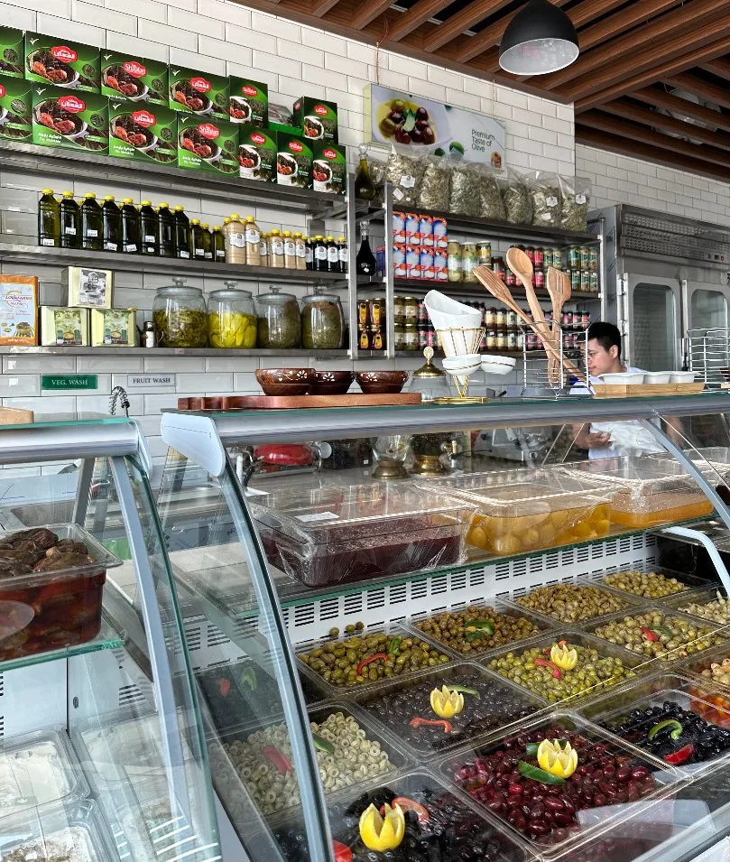 The Manazel Al-Sham deli counter, stocked with olives, pickles, olive oil and mezze
